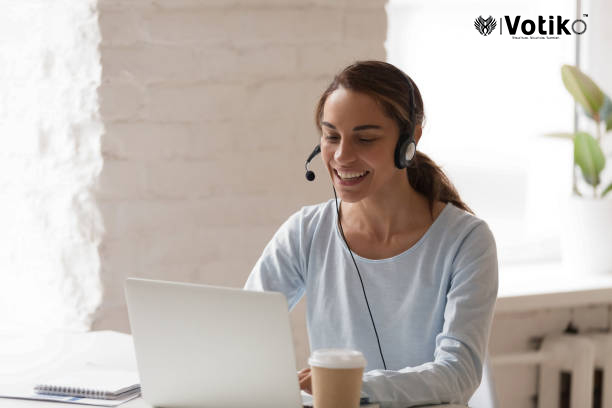 Beautiful smiling woman working in headphones at office. Call center introduction. Happy employee at workplace. People at work at home. Video job interview, language course, class concept